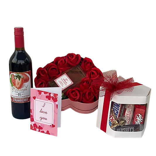 Gift set with wine, chocolate, and candy on a white background