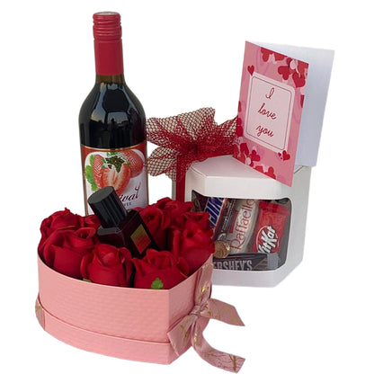 Heart-shaped box with red roses, a bottle of wine, a small bottle, and a card on a white background