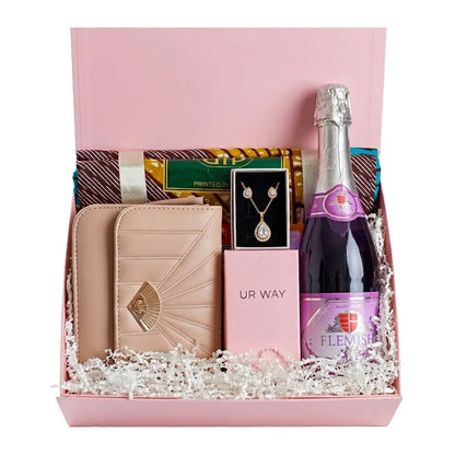 Gift basket with a bottle of champagne, wallet, and jewelry in a pink box.