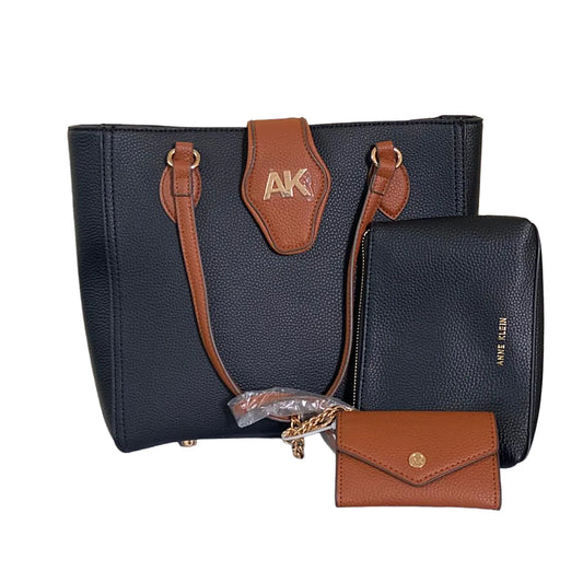 Black handbag with brown accents and 'AK' logo, accompanied by a matching wallet on a white background.