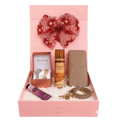 Gift set with perfumes, watches, and accessories in a pink box.