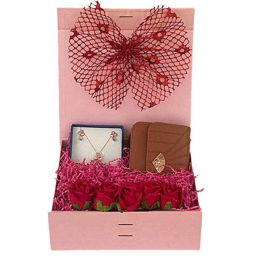 Gift set with jewelry and wallet in a decorative box with red roses and bow