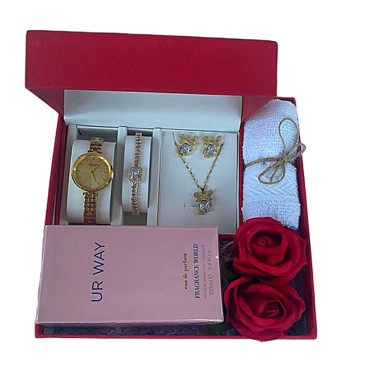 A gift set containing a watch, a jewelry set (necklace and earrings), and a face towel, all packaged in a red box with a pink ribbon.