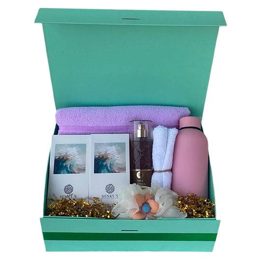 Gift box with a pink water bottle, purple towel, and other items on a white background