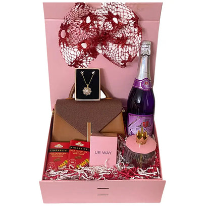 Gift box with a bottle of sparkling wine, jewelry, and other items on a white background