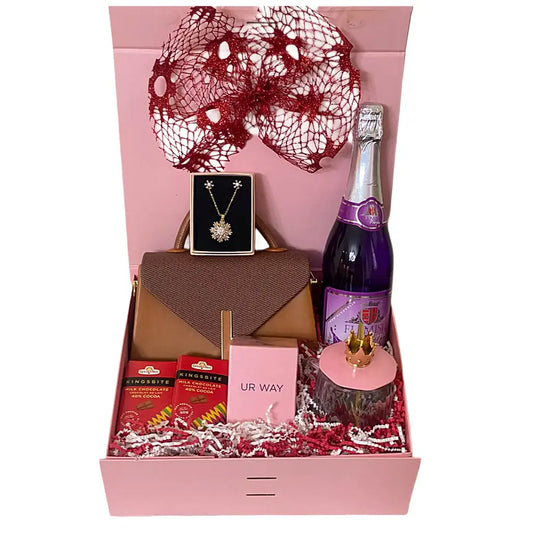 Gift box with a bottle of sparkling wine, jewelry, and other items on a white background