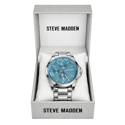 Steve Madden men's analog watch with a silver stainless steel case and bracelet, featuring a textured light blue dial, presented inside its open light gray gift box.